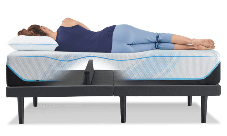 Woman laying on power base with the Lumbar support feature shown