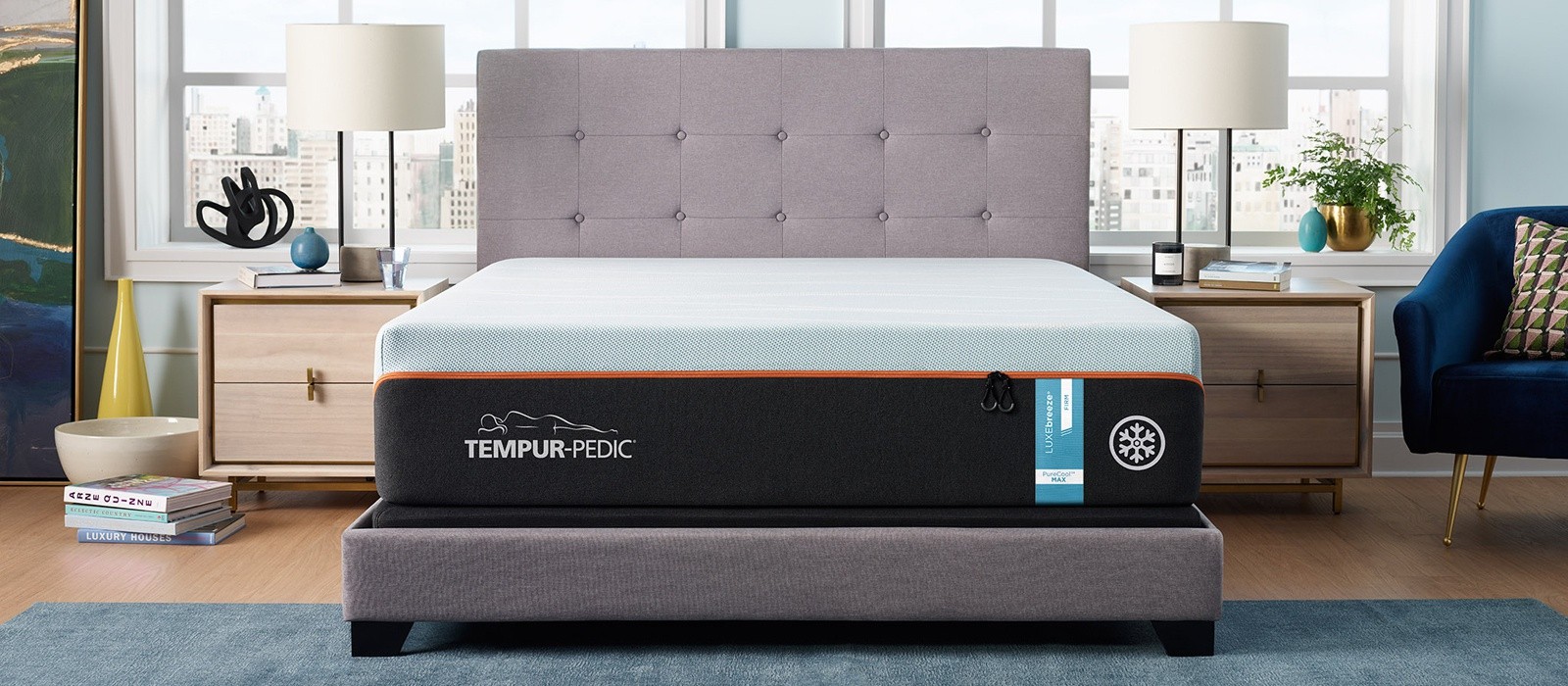 A Tempur-Luxebreeze Queen Firm mattress in a well lit room against a large window
