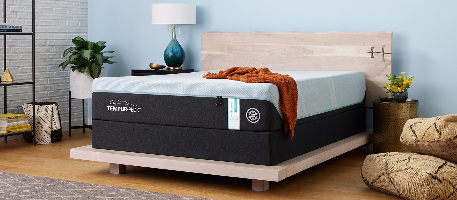 A Tempur-Probreeze Queen Hybrid mattress in a well lit room with a blanket on the top