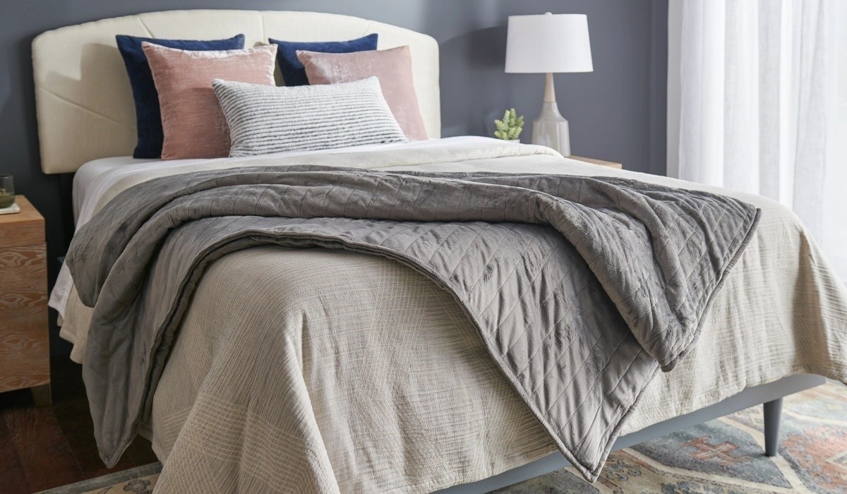 weighted blanket on a dressed bed